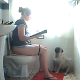 A girl takes a shit while sitting on a toilet (no audible poop sounds). She realizes that there is no toilet paper, so she asks her dog to fetch some. She ends up having to get it herself.
